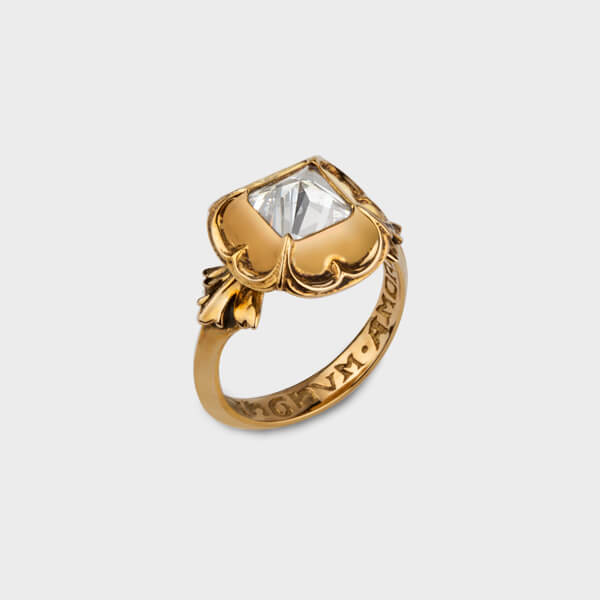 A yellow gold engagement ring with a moissanite stone in the centre.